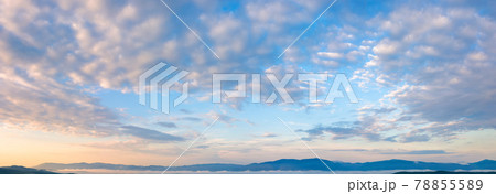 fluffy clouds on the azure sky at sunrise. beautiful nature background. panoramic view in golden morning light 78855589