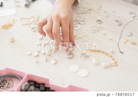 Professional jewelry designer making handmade jewelry in studio workshop close-up. Fashion, creativity and handmade concept 78856017