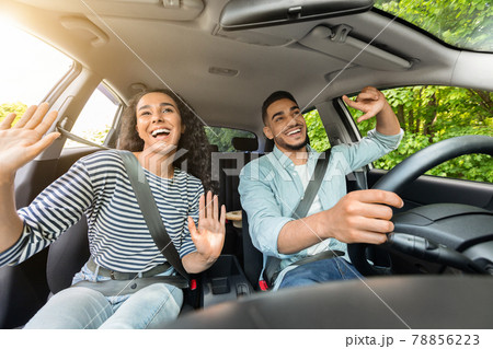 Emotional mixed race couple having fun while car trip Emotional mixed race couple having fun while car trip 78856223
