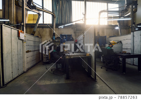 Metal industry worker working in factory, wearing protective face mask during coronavirus or covid19 pandemic.  78857263