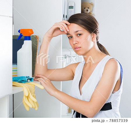 Young female is dreaming while cleaning Young female is dreaming while cleaning 78857339