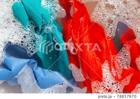 Color clothes soak in powder detergent water dissolution. Laundry concept 78857670