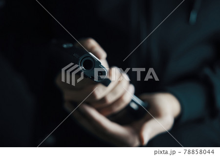 Close up of man reloading pistol. 78858044