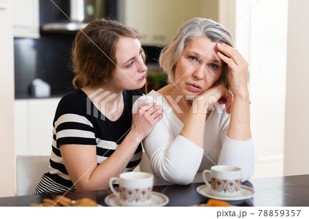 Daughter comforting upset mother 78859357