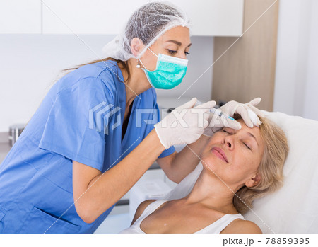Mature female receiving cosmetic injection 78859395