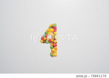 Number four from sweet pastry topping in the form of colorful foliage on a white background. 78861179