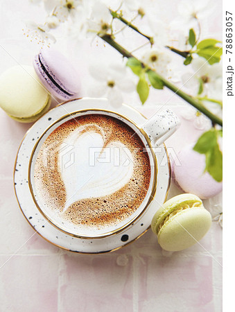 Coffee with a heart-shaped pattern and sweet macaroons desserts Coffee with a heart-shaped pattern and sweet macaroons desserts 78863057