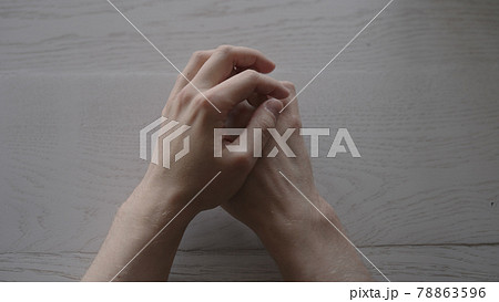 man hands on white oak table with window light while waiting man hands on white oak table with window light while waiting 78863596
