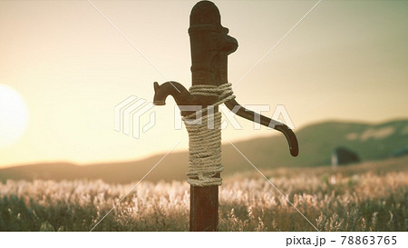 old hand water pump on dry hills old hand water pump on dry hills 78863765