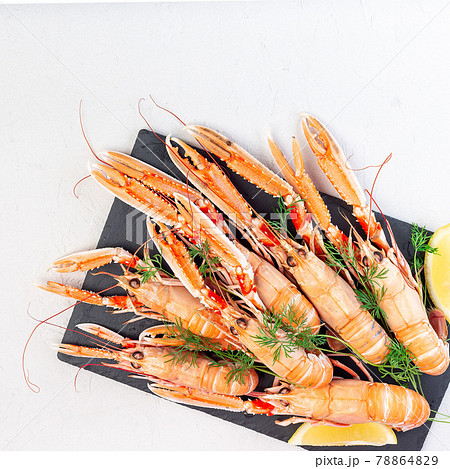 Sea crayfishes on a stone plate served with dill and lemon, top view, copy space, square 78864829