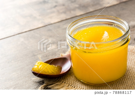 Ghee or clarified butter in jar on wooden table 78868117