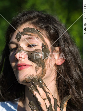 Muddy Face of a Young Woman 78868419