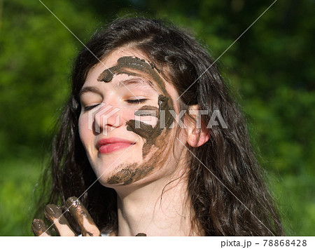 Muddy Face of a Young Woman 78868428