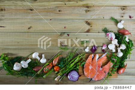 Vegetables, steaks of salmon, mushrooms on wooden background Vegetables, steaks of salmon, mushrooms on wooden background 78868447