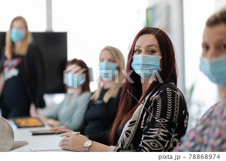 real business people on meeting wearing protective mask 78868974
