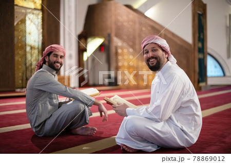 two muslim people in mosque reading quran together concept of islamic education two muslim people in mosque reading quran together concept of islamic education 78869012
