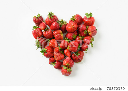 Ugly three ripe organic strawberry on black background. Ugly three ripe organic strawberry on black background. 78870370
