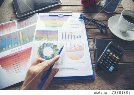 Office laptop business financial document chart and graph on wooden table with coffee cup. Flat lay notebook computer laptop on office desk. No people business graph chart mockup on business workspace 78881305