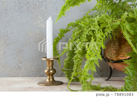 Antique candlestick on concrete background 78891083
