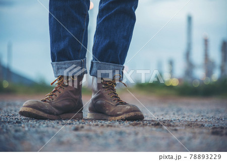 Men wear construction Boots safety footwear for worker at construction site. Engineer Wear Jeans Brown Boots Worker on Background of Refinery. Engineer safety industry fashion footwear walking outdoor 78893229