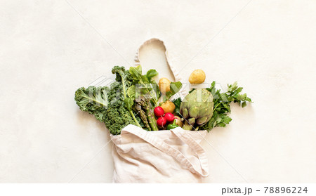 Close up view of the textile eco bag with fresh season vegetables Close up view of the textile eco bag with fresh season vegetables 78896224