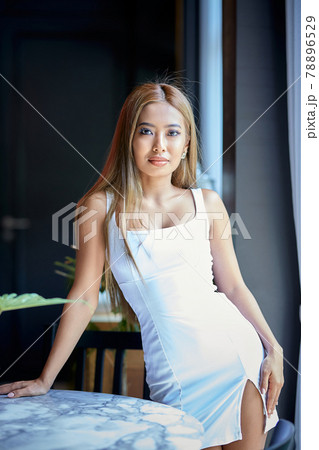 Fashion close-up portrait of young Asian woman posing near to window Fashion close-up portrait of young Asian woman posing near to window 78896529