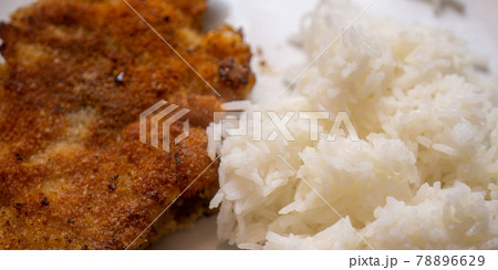 Simple home cooking for a bachelor from a breaded and pan-fried escalope of white boiled rice, simple dish Simple home cooking for a bachelor from a breaded and pan-fried escalope of white boiled rice, simple dish 78896629