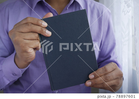young man hand holding a book with empty space  78897601