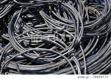 A twisted copper wire in black plastic insulation lies in a pile. Electrification and automation of 78899774