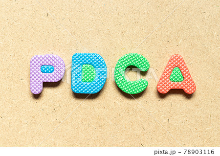 Foam alphabet letter in word PDCA (Abbreviation of plan do check act) on wood background 78903116
