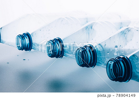 Used transparent plastic bottles on light blue background. Group of plastic for reuse recycling. Waste bottle recycling Used transparent plastic bottles on light blue background. Group of plastic for reuse recycling. Waste bottle recycling 78904149