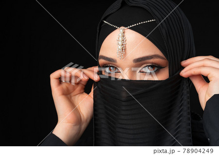 Close up portrait of beautiful muslim girl dressed in hijab 78904249