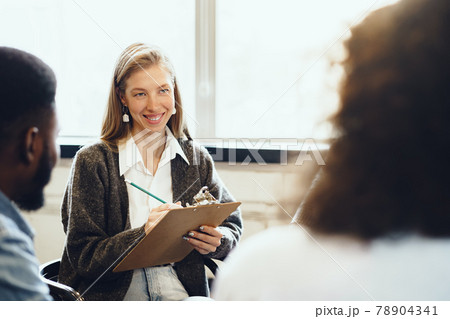 Young people sitting in a circle and having a discussion 78904341