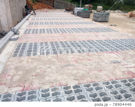 PENANG, MALAYSIA -JUNE 16, 2021: Concrete interlocking pavers and material under construction at the construction site. Used for pedestrian walkway and parking lot. Advantages in durability and heav PENANG, MALAYSIA -JUNE 16, 2021: Concrete interlocking pavers and material under construction at the construction site. Used for pedestrian walkway and parking lot. Advantages in durability and heav 78904446