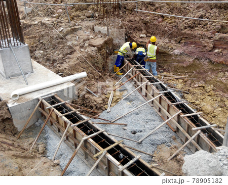 SELANGOR, SEPTEMBER 17, 2015: Building ground beam reinforcement bar and form work fabricated at site by construction workers. Concrete will be four into it after satisfied by engineer.  78905182