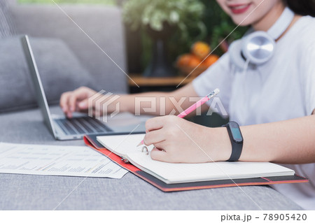 Young student watching lesson online and studying from home. She using laptop and learning online. Distance learning online education. Young student watching lesson online and studying from home. She using laptop and learning online. Distance learning online education. 78905420
