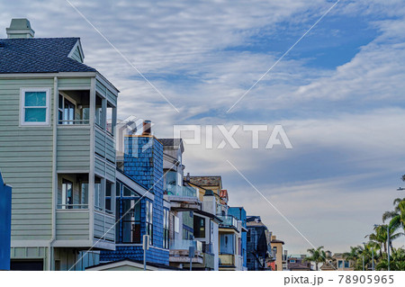Clouds and blue sky over houses and palm trees in Huntington Beach neighborhood Clouds and blue sky over houses and palm trees in Huntington Beach neighborhood 78905965