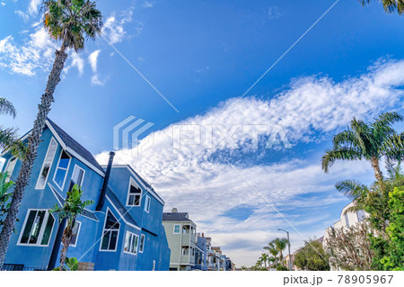 Looking up to vibrant blue sky with puffy clouds over houses in Huntington Beach Looking up to vibrant blue sky with puffy clouds over houses in Huntington Beach 78905967