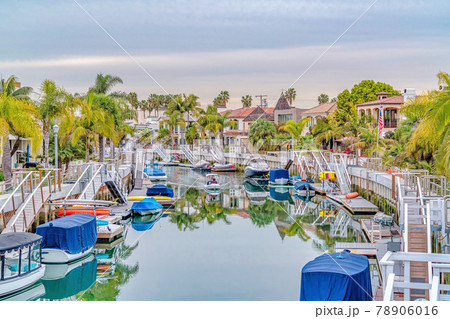 Scenic canal with stairs going down boat ramps at a resort like neighborhood 78906016