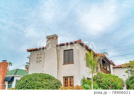 Exterior of two storey house with concerete wall balcony and chimney against sky Exterior of two storey house with concerete wall balcony and chimney against sky 78906021