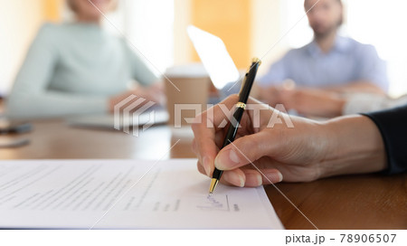 Close up businesswoman signing contract at group negotiation Close up businesswoman signing contract at group negotiation 78906507