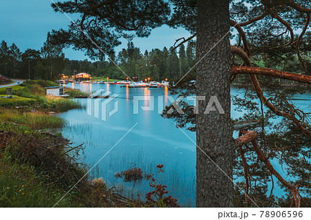 Sweden. Road To Beautiful Swedish Village near Lake. Wooden Log Cabin Houses In Summer Evening Night. Lake Or River Landscape 78906596