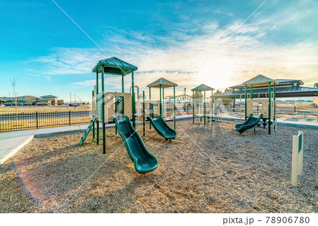 Childrens playground at neighborhood park in Utah Valley against cloudy blue sky 78906780