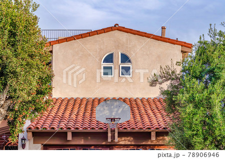 Basketball hoop mounted on red tile roof of home in Huntington Beach California 78906946