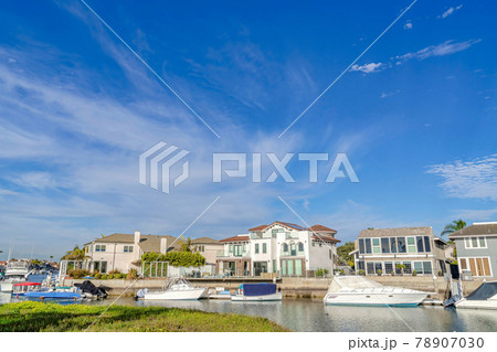 Serene blue sky over houses overlooking boats at the harbor in Huntington Beach Serene blue sky over houses overlooking boats at the harbor in Huntington Beach 78907030