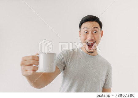 Surprised face of man drinks a cup of coffee isolated on white background. Surprised face of man drinks a cup of coffee isolated on white background. 78907280