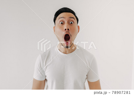 Funny shocked and surprised face of man isolated on white background. 78907281
