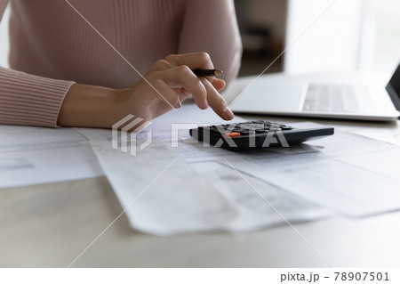 Close up of woman manage finances at home Close up of woman manage finances at home 78907501