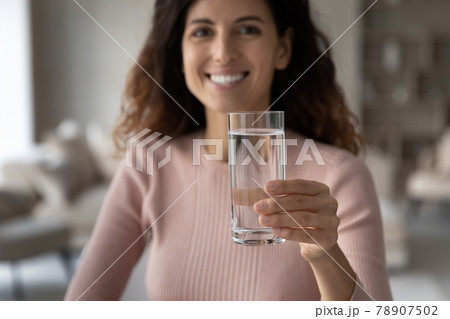 Close up of happy Latin woman recommend drinking water Close up of happy Latin woman recommend drinking water 78907502