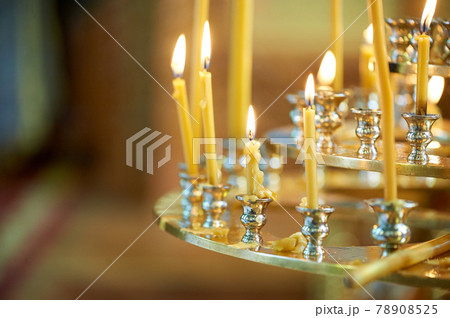 Three-tier candlestick with candles in the Orthodox Church 78908525